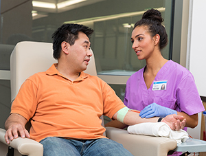 Healthcare provider caring for man donating blood.